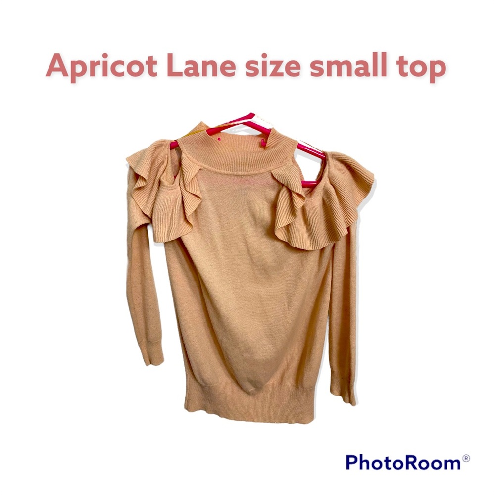 Beautiful cold shoulder sweater top with ruffles.